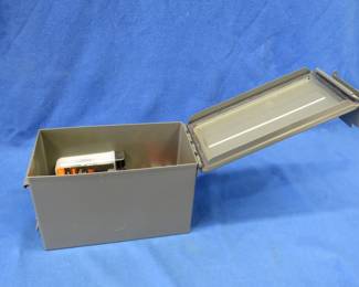 Lot 359. Metal ammo can with different shooting items, including 5 12-gauge slugs, cleaning kits, and a few pistol primers