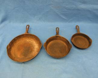 Lot 97. Three cast iron skillets including one Griswold