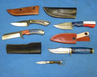 Lot 367. Five new knives. Four fixed blade with leather sheaths and one folding pocket knife.