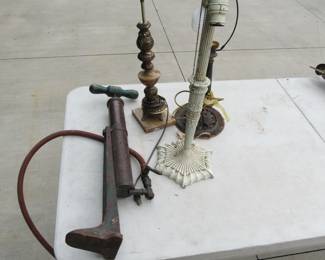 Lot 111. Three lamps (one appears to be copper) and a pump with a copper tube