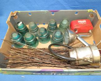 Lot 219. Glass insulators, barbed wire, and an old flashlight