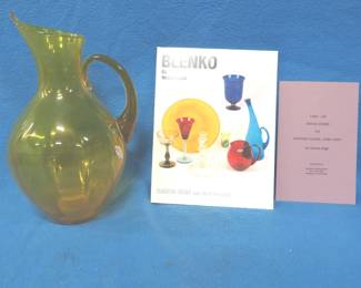 Lot 51. 13 inches tall hand-blown Blenko amber glass pitcher with catalog and price guide and Blenko book.