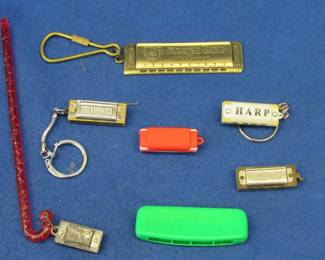 Lot 161. Four novelty harmonicas, one key chain fob, and one fake plastic harmonica