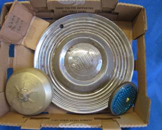 Lot 374. Old Pontiac hubcaps and a wind up fire alarm that works.