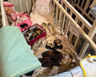 Vintage dolls and baby cradles and clothes