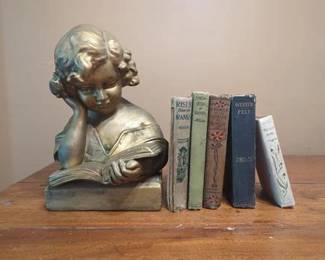 An Assortment of Antique Books with Ceramic Bookend