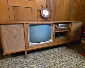 vintage mid-century modern Curtis Mathest, integrated cathode-ray tube (CRT) television, a radio receiver, and a record player turntable enclosed in a long wooden cabinet with fabric speaker grills on either sside. Absolutely Beautiful!! Did not plug in to test.