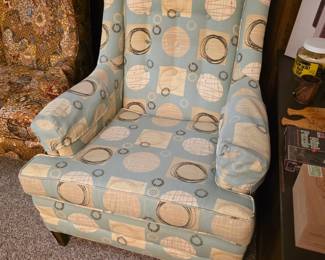 wingback armchair with tufted buttons on the backrest.
