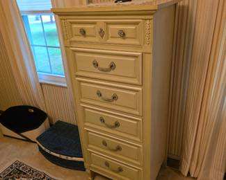 vintage French Provincial-style lingerie chest by Dixie Furniture with a cream finish, ornate brass hardware and six vertical drawers.