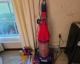 red Dyson DC07 Root Cyclone upright vacuum cleaner.