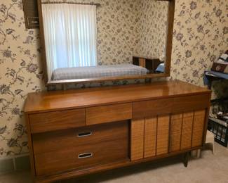 mid-century modern walnut lowboy dresser and matching mirror from the Mainline collection by Hooker Furniture, featuring distinctive sliding cane-front cabinet doors. Excellent condition!