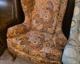 Drexel, wingback armchair upholstered in a warm earth-toned floral print with classic carved wooden cabriole legs. Ask a follow-up
