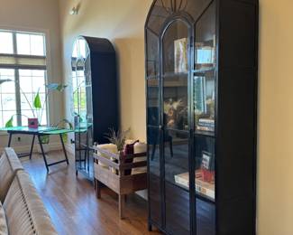 Two 7'6" x 39" tall black metal and glass arched apothecary cabinets, purchased from Checkered Moon in Champaign. Cabinets are 39" x 16" 7'6