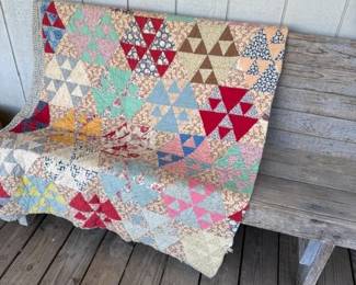 Many homemade quilts, most vintage, on top of this primitive pew
