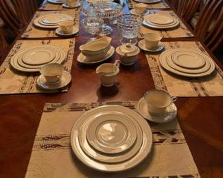 48 piece Columbia  Old Irvory Syracuse China on top of wooden table, 2 leaves for 10