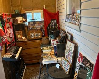 Back porch has several old crates and a nice selection of coffee table books, a vintage dresser and more