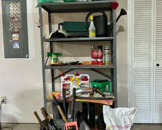 Metal Shelving Unit with Gardening Tools and Lawn Care Supplies