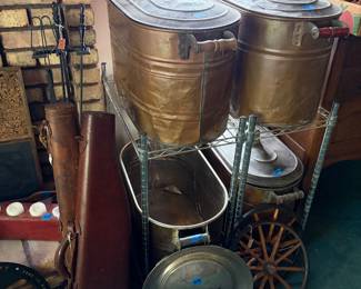 Antique copper boilers, antique leather gun cases, antique wood spike wheels, antique hub cap