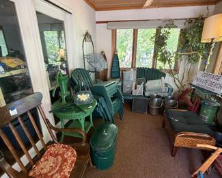 Antique rocking chair, vintage wicker table, vintage pump, green painted copper boilers, plastic Adirondack furniture, bakers rack, canoe shelves, padded wicker bench, vintage wood scooter, miscellaneous metal office organizers