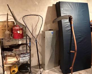 Antique cans and scythe, fishing net, aluminum rod case, twin size mattress pads