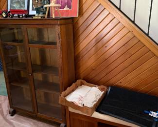 Antique glass front bookcase, padded wood bench, bank coin bags, new floor mats