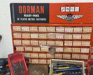vintage Dorman Ready Paks metal wall-mount display cabinet filled with assorted metric fasteners, cap screws, and nuts