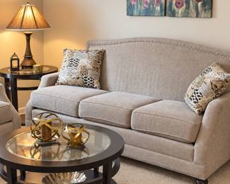 Quality sofa and loveseat with nail head accents, coffee table with matching end table 