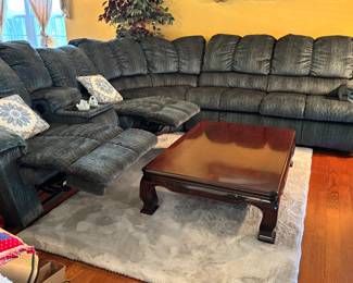 Sectional sofa with recliners and console    Large solid dark wood Asian-style low coffee table with glossy top and carved sides 