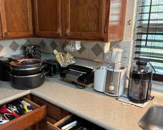Tons of kitchen items : Gotham steel new used fry pan, spice jars and racks, toaster, George Foreman grill, Bella juicer..etc