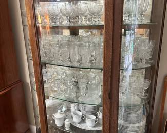 This second magnificent carved china cabinet is full of antique stemware
