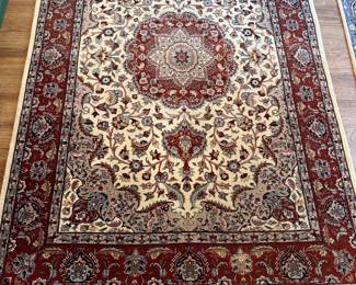 #83 - $ - Cream and red area carpet