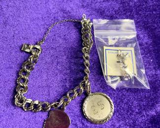 Heavy charm bracelet marked Sterling with a few charms 32 g