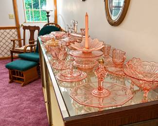 Multiple pieces of pink depression glass