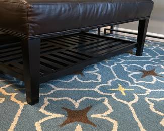 dark leather coffee table ottoman, blue area rug