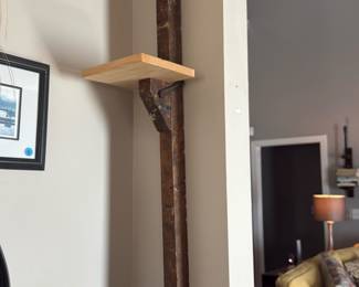 rustic wall shelf made by mounting a vintage wooden screw clamp