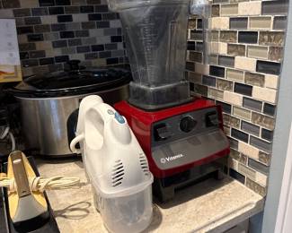 red Vitamix Drink Machine Advance commercial blender, hand mixer, slow cooker