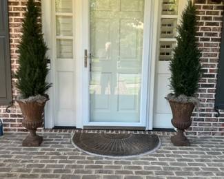 Two Potted Evergreen Topiary Trees with Urn Planters and Doormat