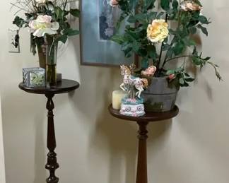 Two Wooden Pedestal Tables with Floral Arrangements and Framed Art