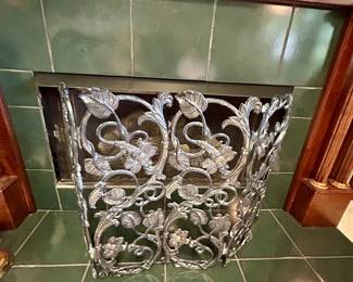 Decorative metal fireplace screen with scrolling floral design