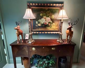Traditional mahogany bow-front sideboard with a center drawer, two side cabinets, brass hardware and tapered legs.