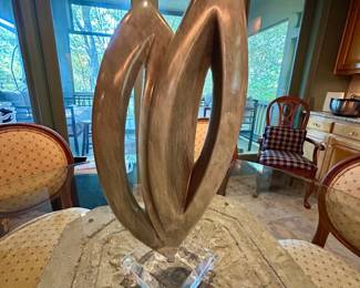 Decorative abstract sculpture on a clear acrylic base.