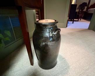 Tall black glazed stoneware crock with side handles and lid