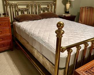Polished brass bed frame with decorative posts and matching headboard and footboard