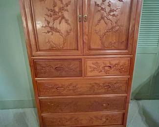 Asian-style carved wardrobe chest with bird-and-blossom cabinet doors and six lower drawers