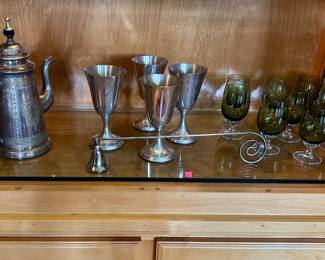 Vintage metal coffee pot, four silver-tone goblets, and a set of smoky green stemware