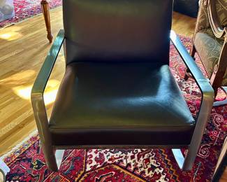 Contemporary black upholstered accent chair with a brushed metal frame