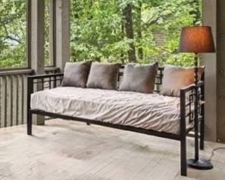 Two black metal daybeds with matching pull-out trundles and mattresses