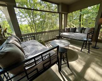 Two black metal daybeds with matching pull-out trundles and mattresses 
