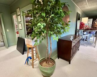 Tall decorative indoor tree in a green ceramic planter