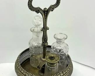 Vintage silverplated cruet set with an ornate handle and glass Condiment Holders